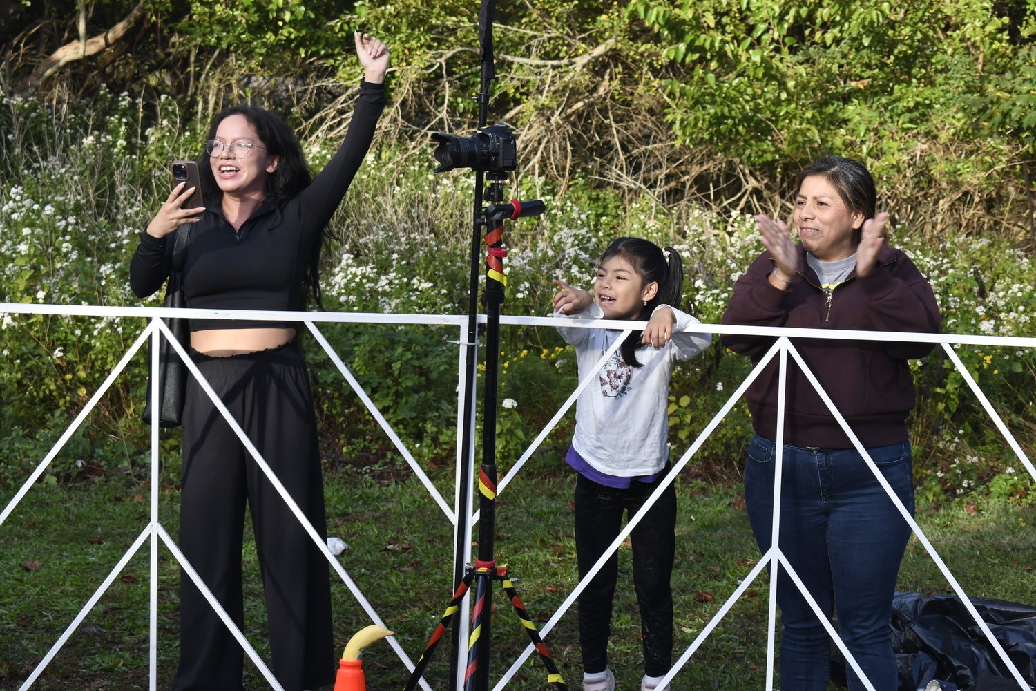 Fans cheer on finishers at the finish line at Agawam Park on Saturday morning. DREW BUDD