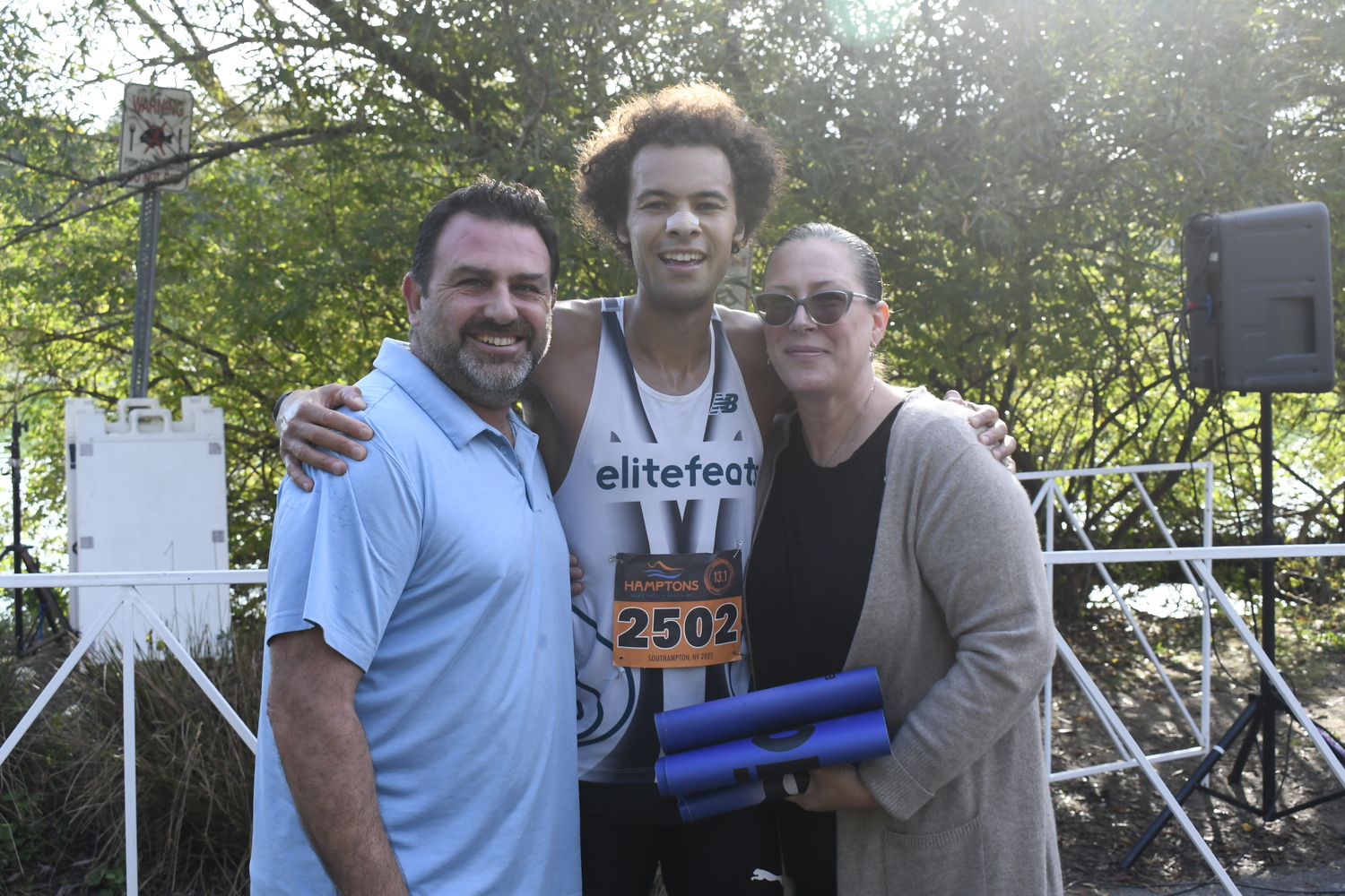 Jordan Daniel with his father and mother Kaan and Christina Berent after winning the Hamptons Half Marathon on Saturday.  DREW BUDD