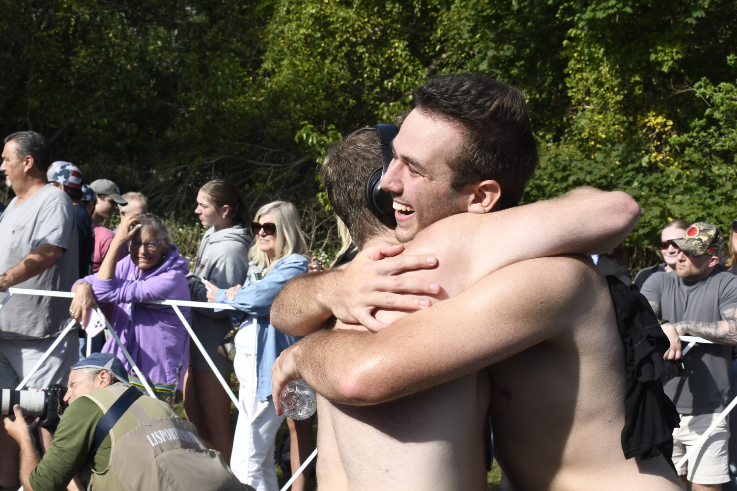 Friends embrace  each other after finishing the half marathon. DREW BUDD