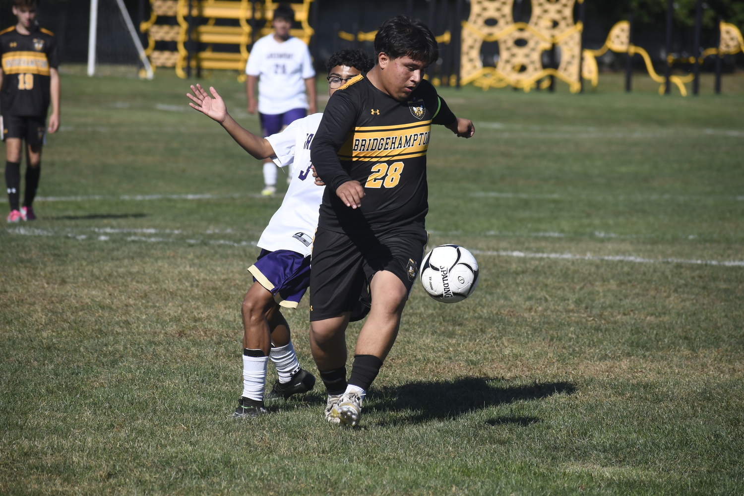Bridgehampton senior co-captain Devyer Cabanas gets to the ball before Greenport eighth-grader Yomar Contreras.  DREW BUDD