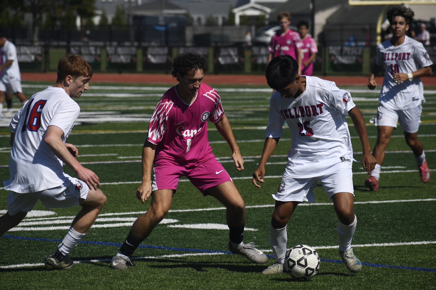 Westhampton Beach senior Markus Rahbari looks to disrupt a Bellport player.  DREW BUDD