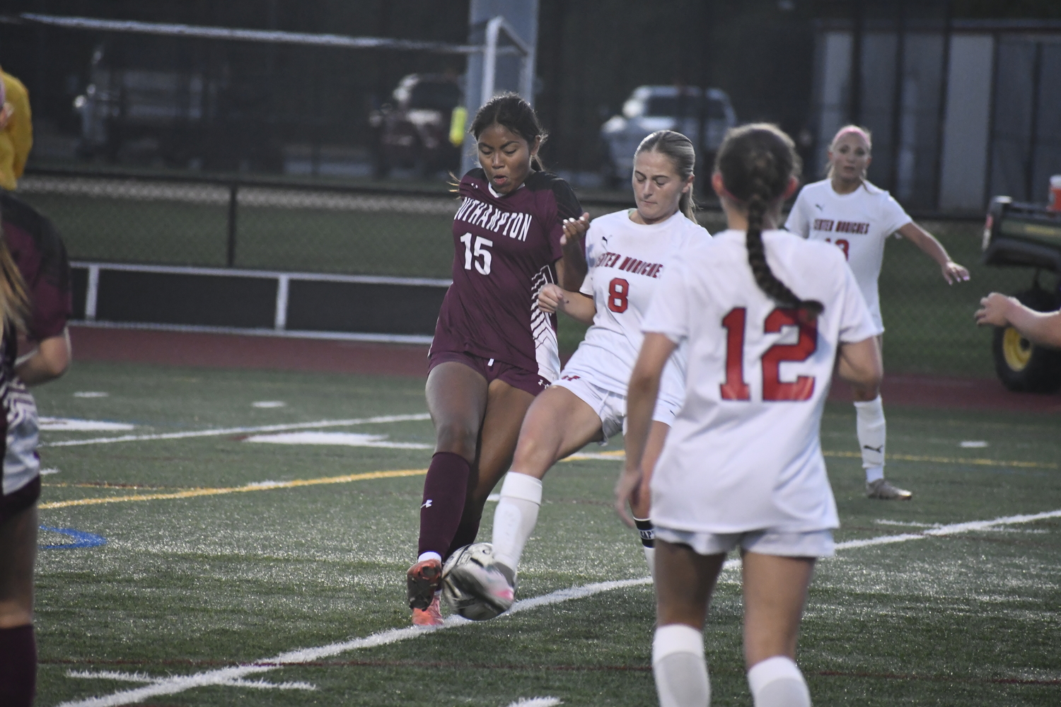 Southampton junior Melanie Feliciano and Center Moriches junior Emmy Hiller converge on a ball. DREW BUDD