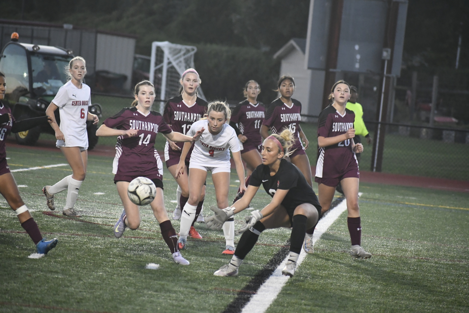 Riley Cameron and the Mariners try to play the ball in the box but Center Moriches goalie Gabriella Cerillo comes out to play it.
