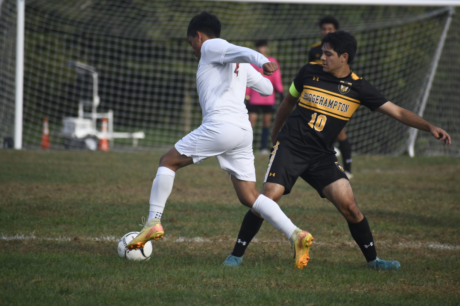 Bridgehampton senior co-captain Luis Penafiel tries to step in front of Pierson senior Erick Bautista.  DREW BUDD