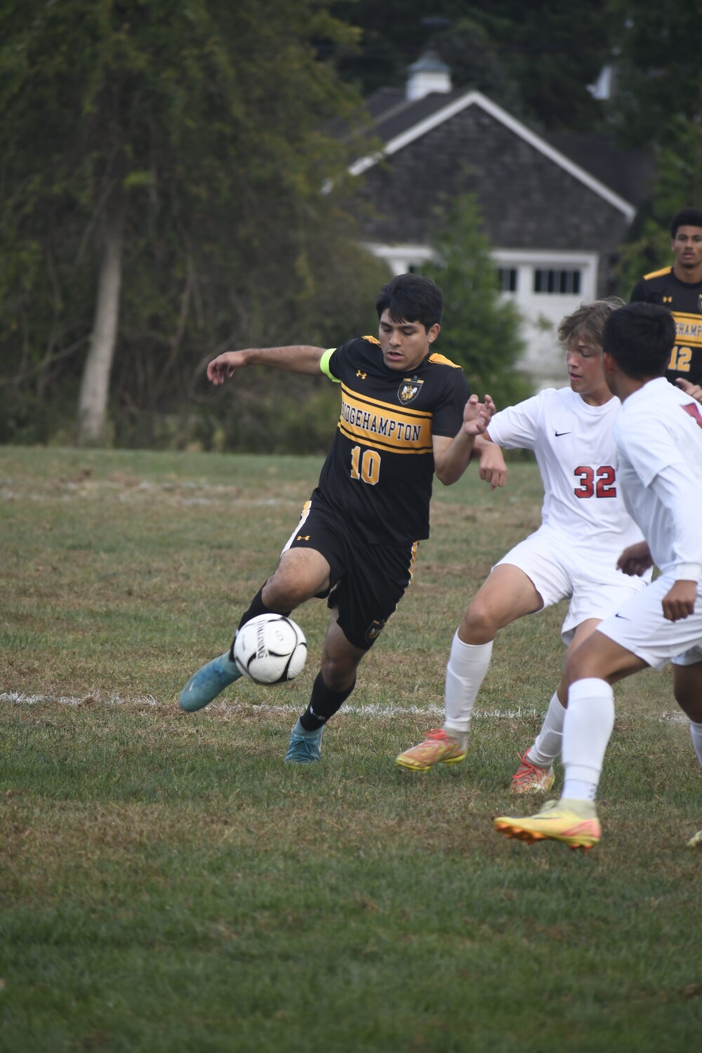 Bridgehampton senior co-captain Luis Penafiel tries to rush ahead with Pierson junior Lochlin Beard defending.  DREW BUDD