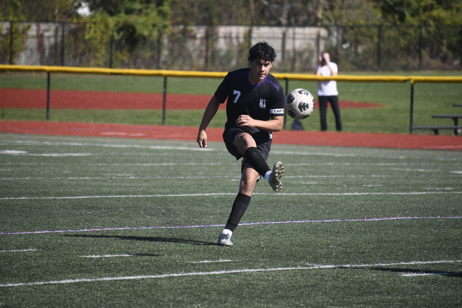 Hampton Bays senior co-captain Eddy Cabrera sends a free kick upfield.  DREW BUDD