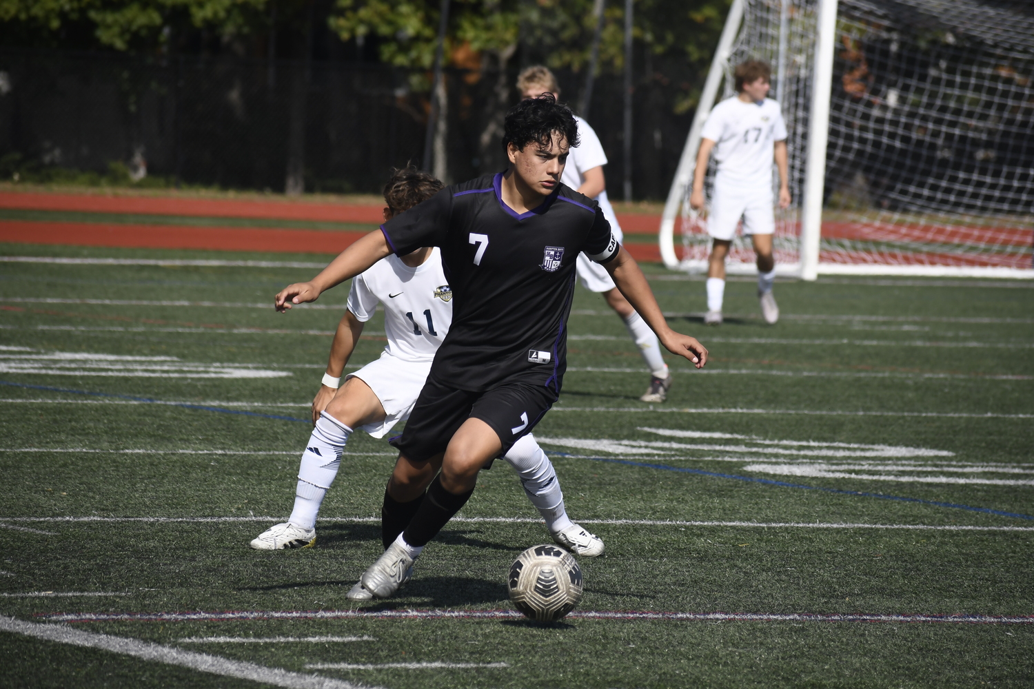 Hampton Bays senior co-captain Eddy Cabrera works the ball and looks for an open teammate.  DREW BUDD