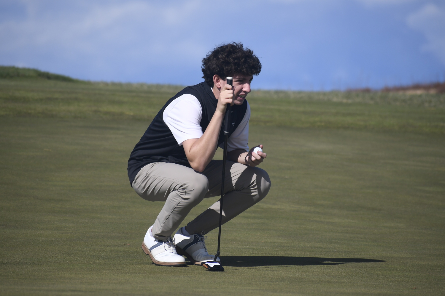 Westhampton Beach freshman Danny Schumacher lines up a putt.  DREW BUDD