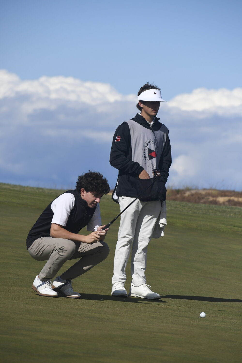 Danny Schumacher gets a little help from caddie and teammate Nico Arena.  DREW BUDD