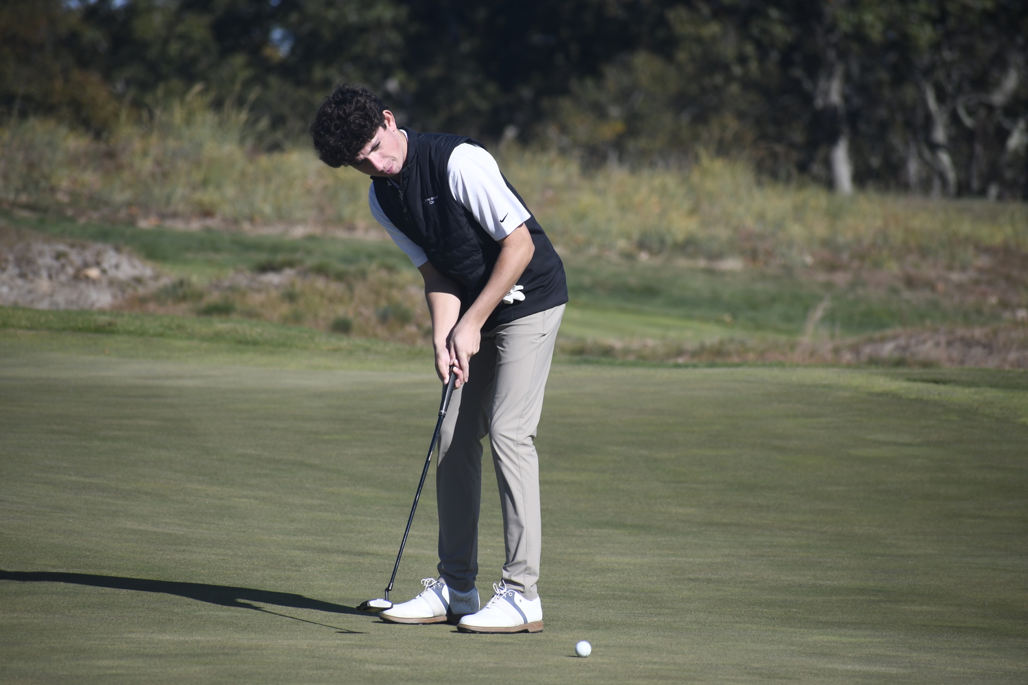 Westhampton Beach freshman Danny Schumacher putts.  DREW BUDD