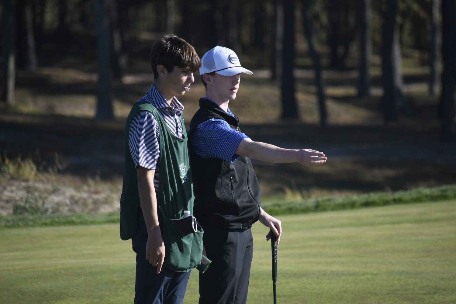 Pierson's Spencer Cavaniola lines up a shot with caddie/teammate Jack Fuer. DREW BUDD