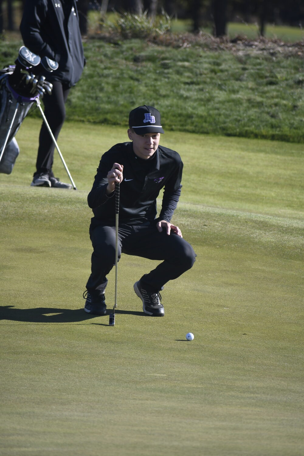 Hampton Bays senior John Tedesco lines up a putt.  DREW BUDD