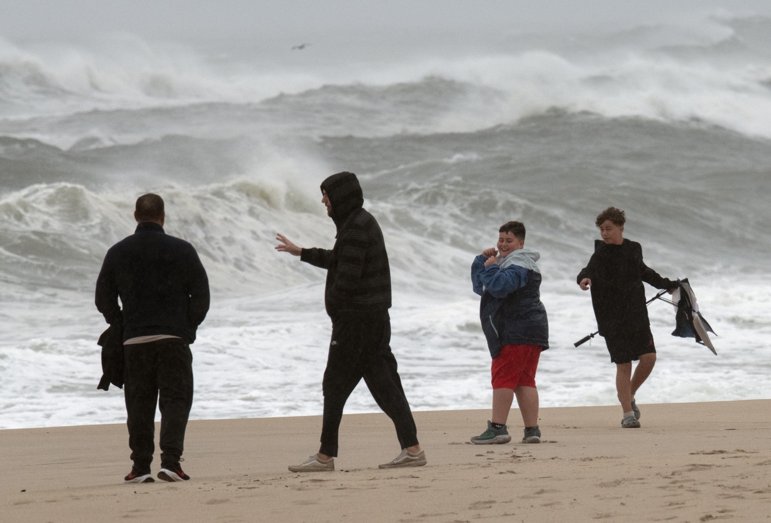 An umbrella becomes a casualty at East Hampton Village Main Beach on Monday afternoon.   DOUG KUNTZ