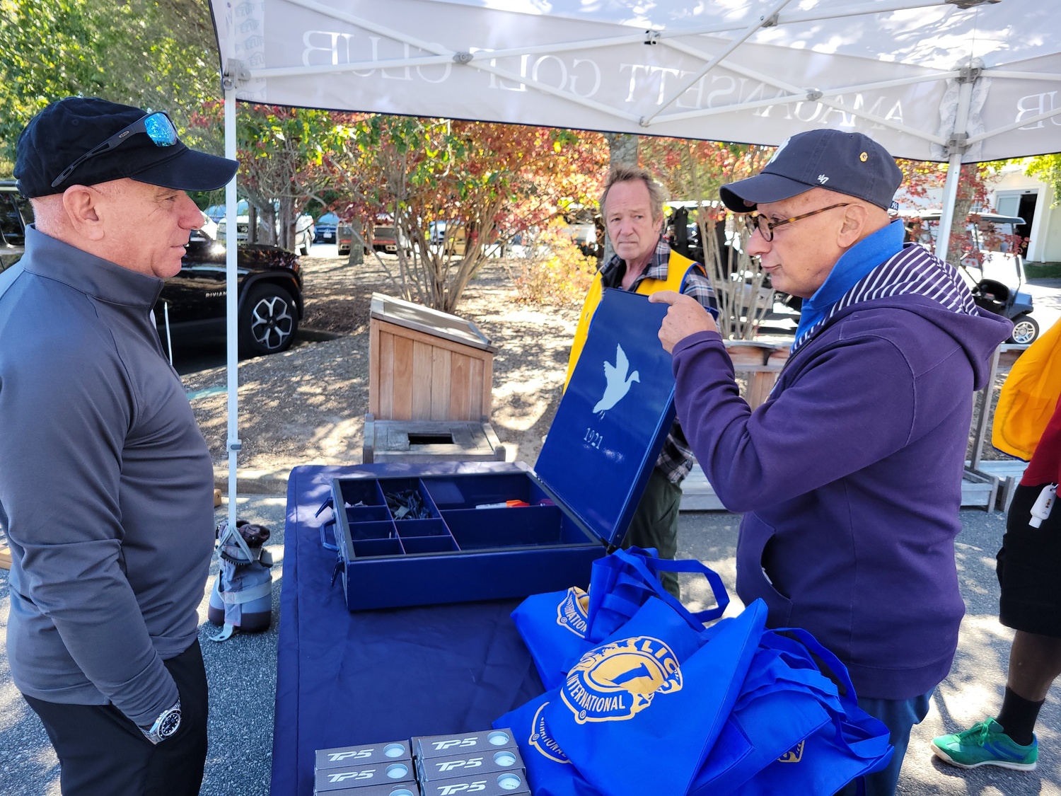 The East Hampton Lions Club held its annual golf outing at the Amagansett Golf Club on October 2. Helping out was event chair Al Giaquinto, right, explaining the day's program to one of the golfers, while Sean Murphy looks on. COURTESY EAST HAMPTON LIONS CLUB