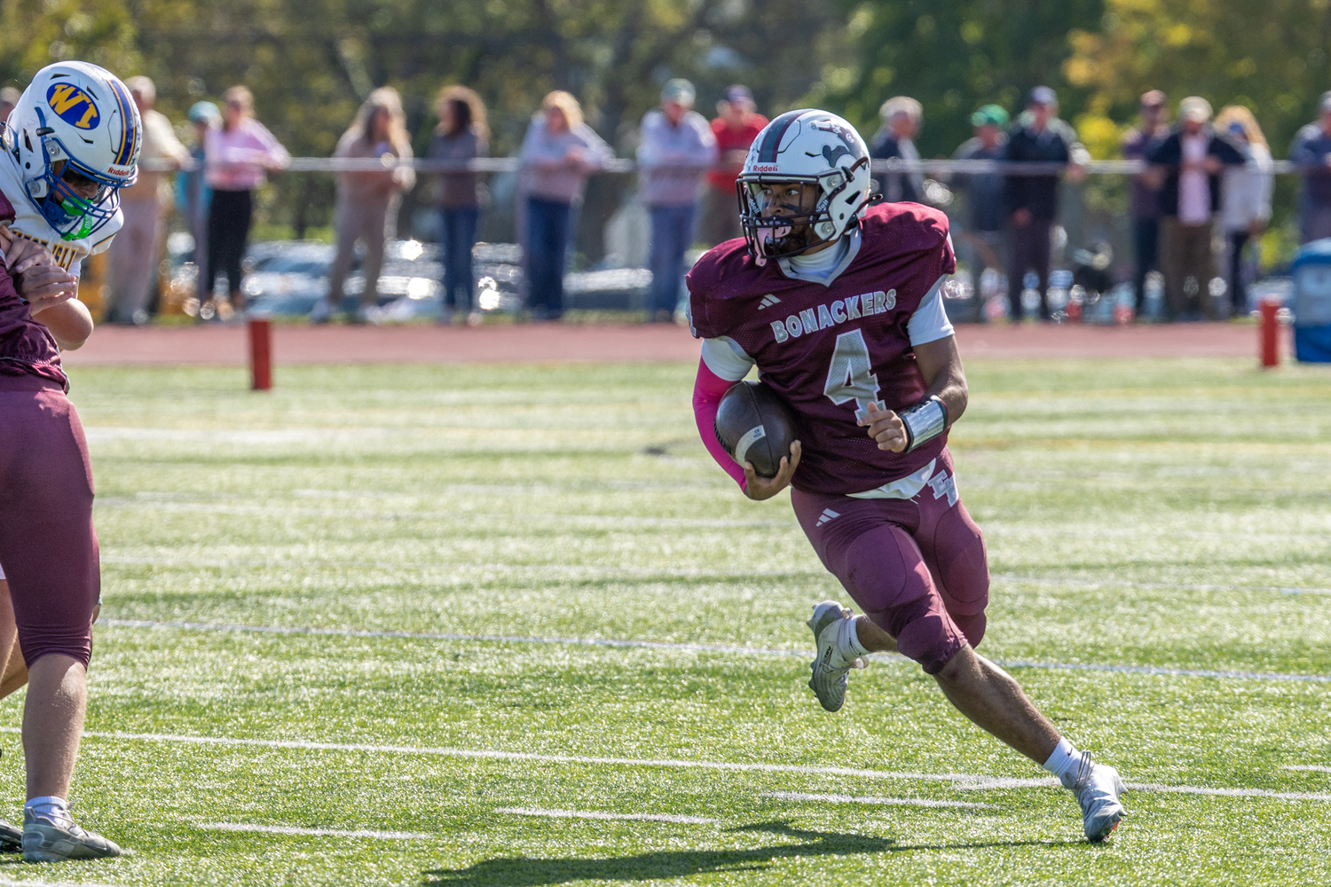Bridgehampton senior Alex Davis sees a block ahead and starts to look upfield. RON ESPOSITO