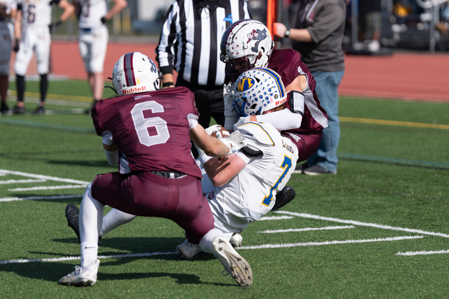 Bonackers Livs Kuplins (6) and Cole Dunchick (1) wrap up West Islip's Conor Kenefick. RON ESPOSITO