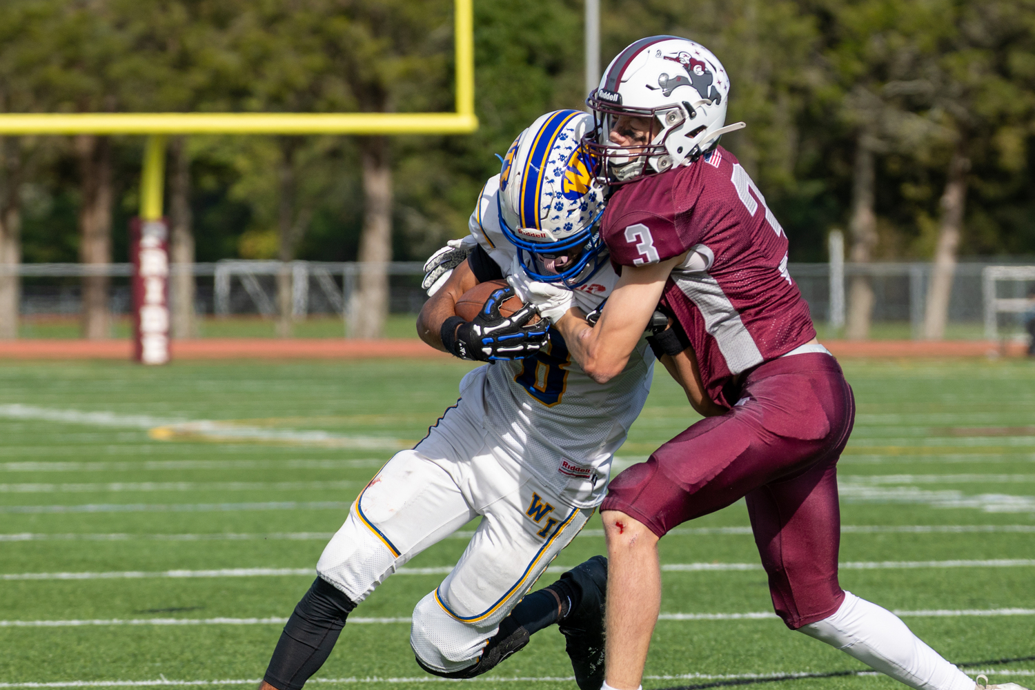 East Hampton junior Jackson Carney tackles a West Islip player.  RON ESPOSITO