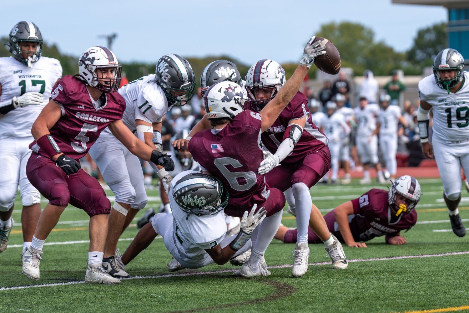 East Hampton senior Livs Kuplins stretches out with the ball while being taken down by Westhampton Beach junior Kyle Coffey.  RON ESPOSITO