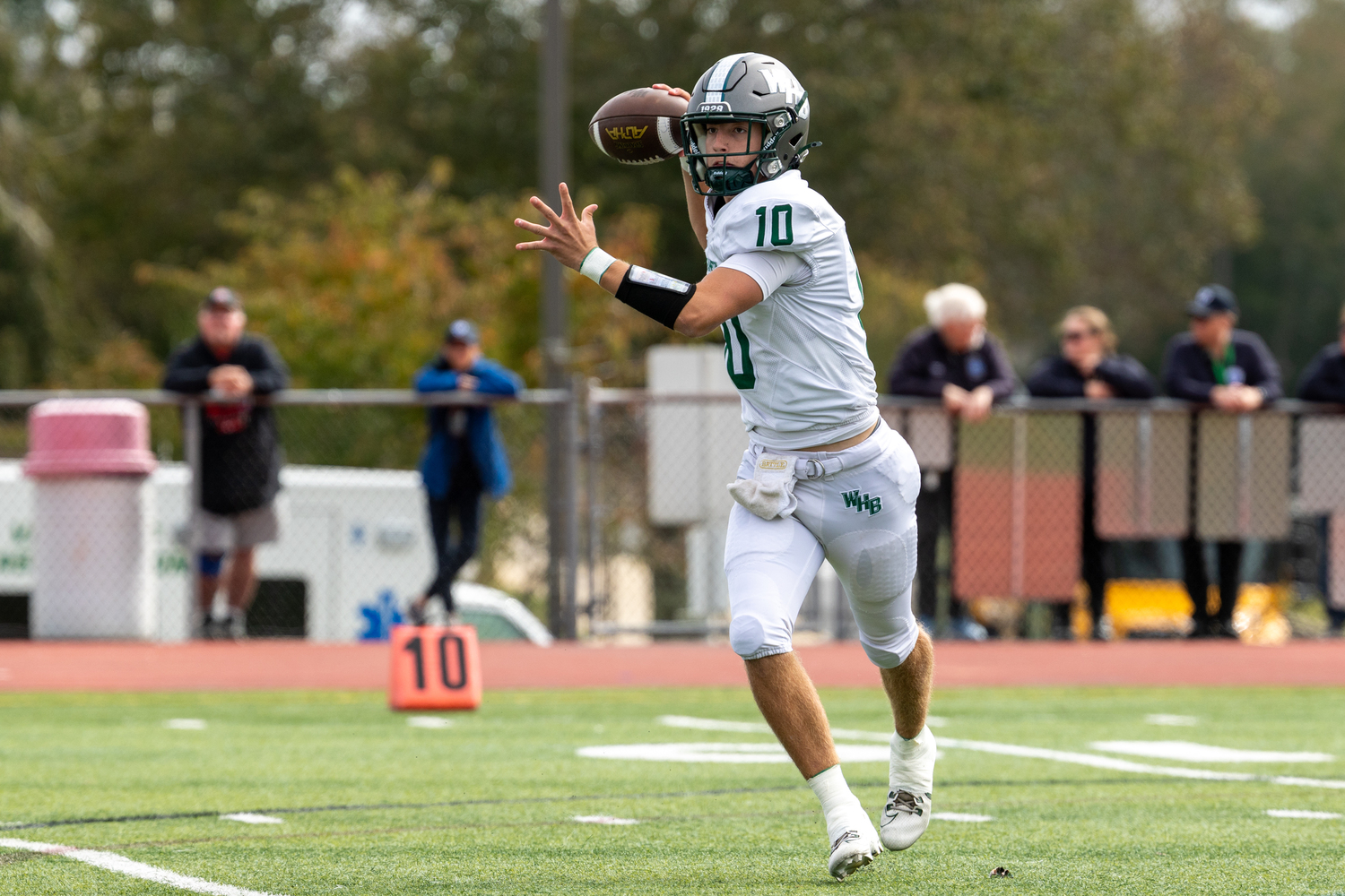 Westhampton Beach senior Pat Fay reaches back to pass on the run. RON ESPOSITO