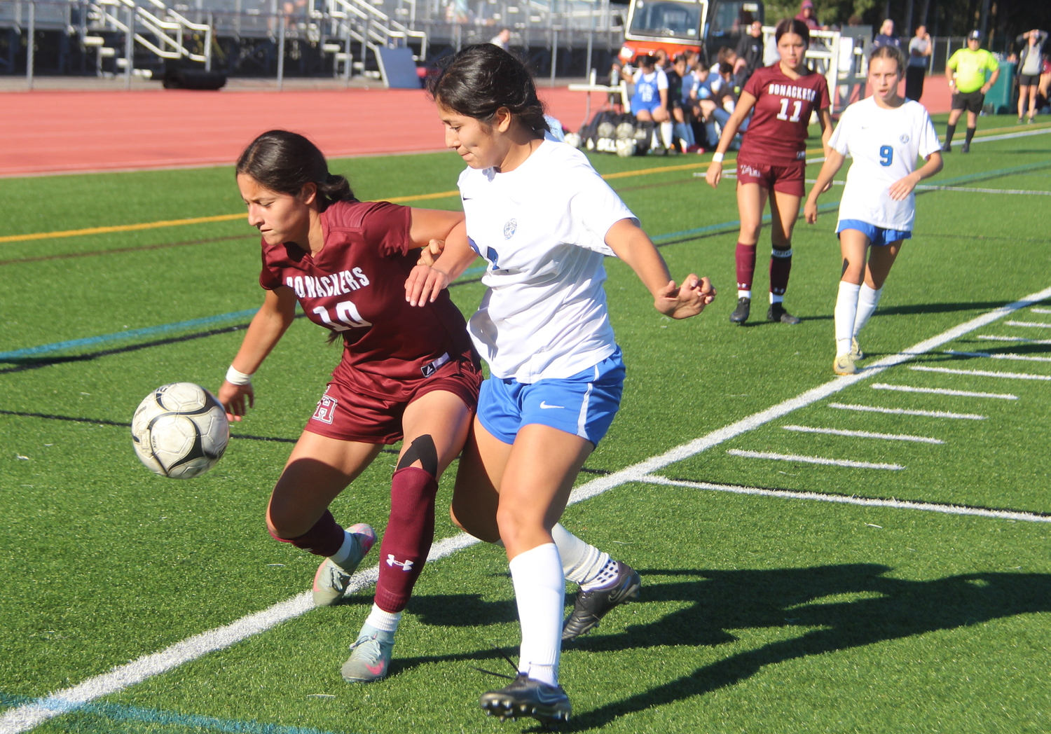 Amy Torres fends off a Riverhead defender.  JACK GRAVES