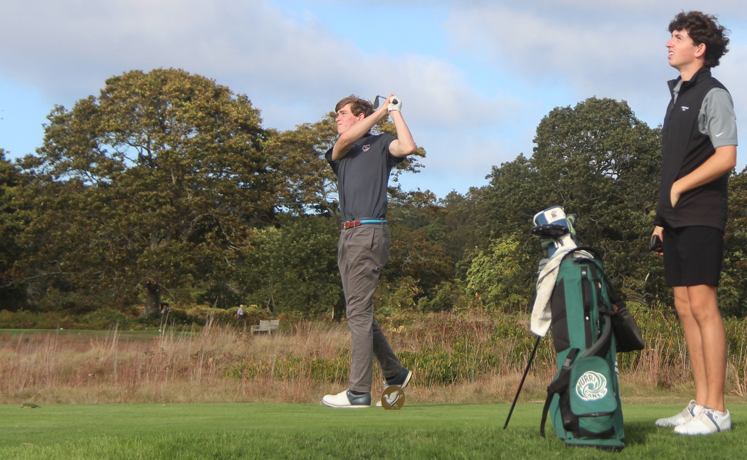 East Hampton's Colin Kelly tees off with Danny Schumacher of Westhampton Beach looking on on October 6.  JACK GRAVES