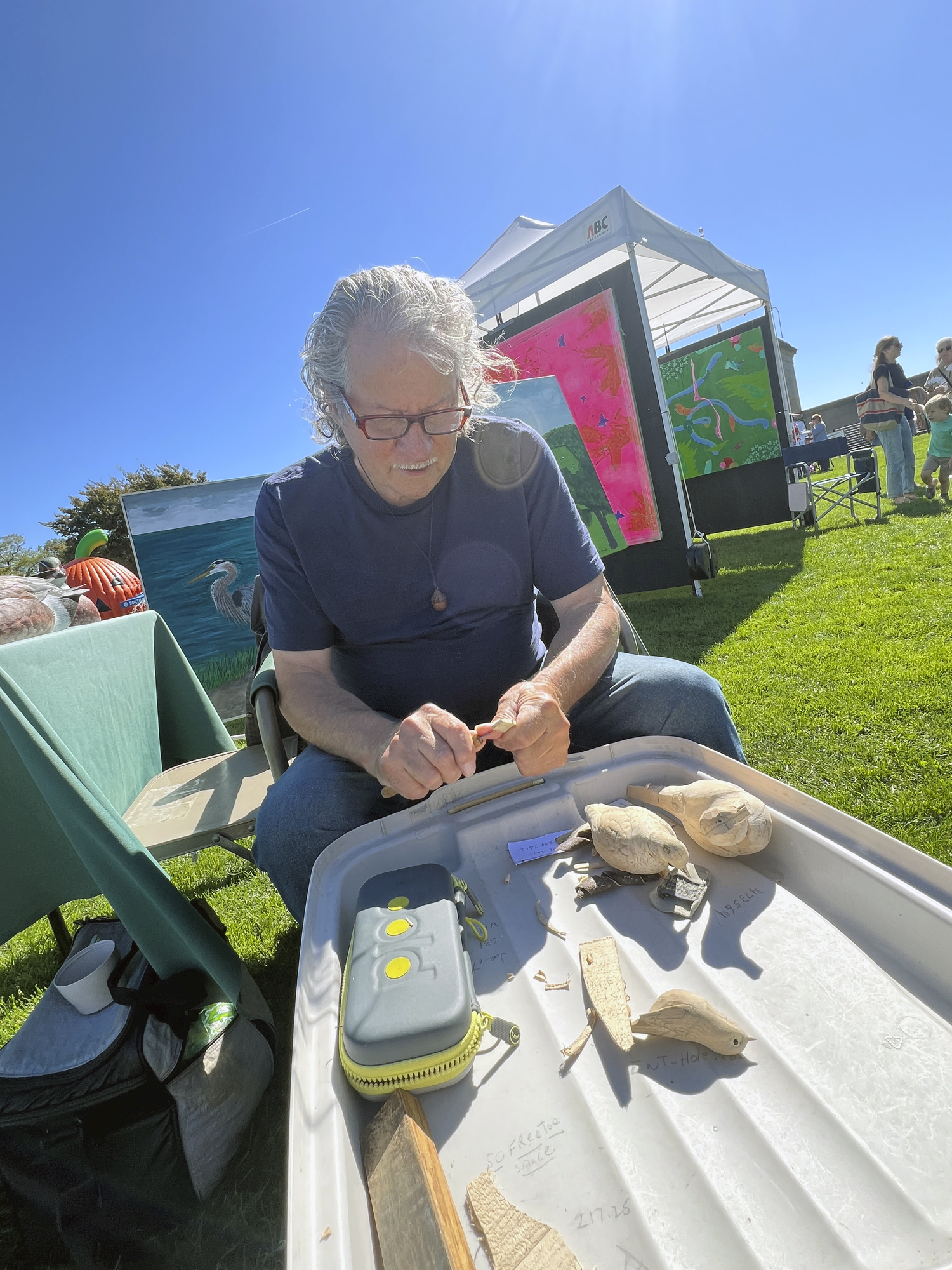 Craftsman Matthew DiBernardo carves a mourning dove at Southamptonfest on Saturday.