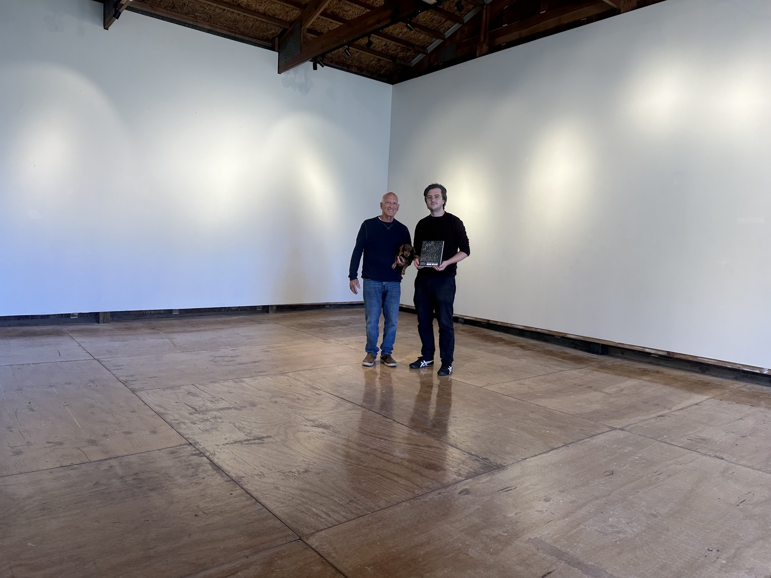 Artist Jonathan Nash Glynn and Connor Flanagan, executive director of the Bridgehampton Museum, stand in the newly renovated Tractor Barn on the Corwith House property. Beginning this weekend, Glynn's work will adorn the walls in 