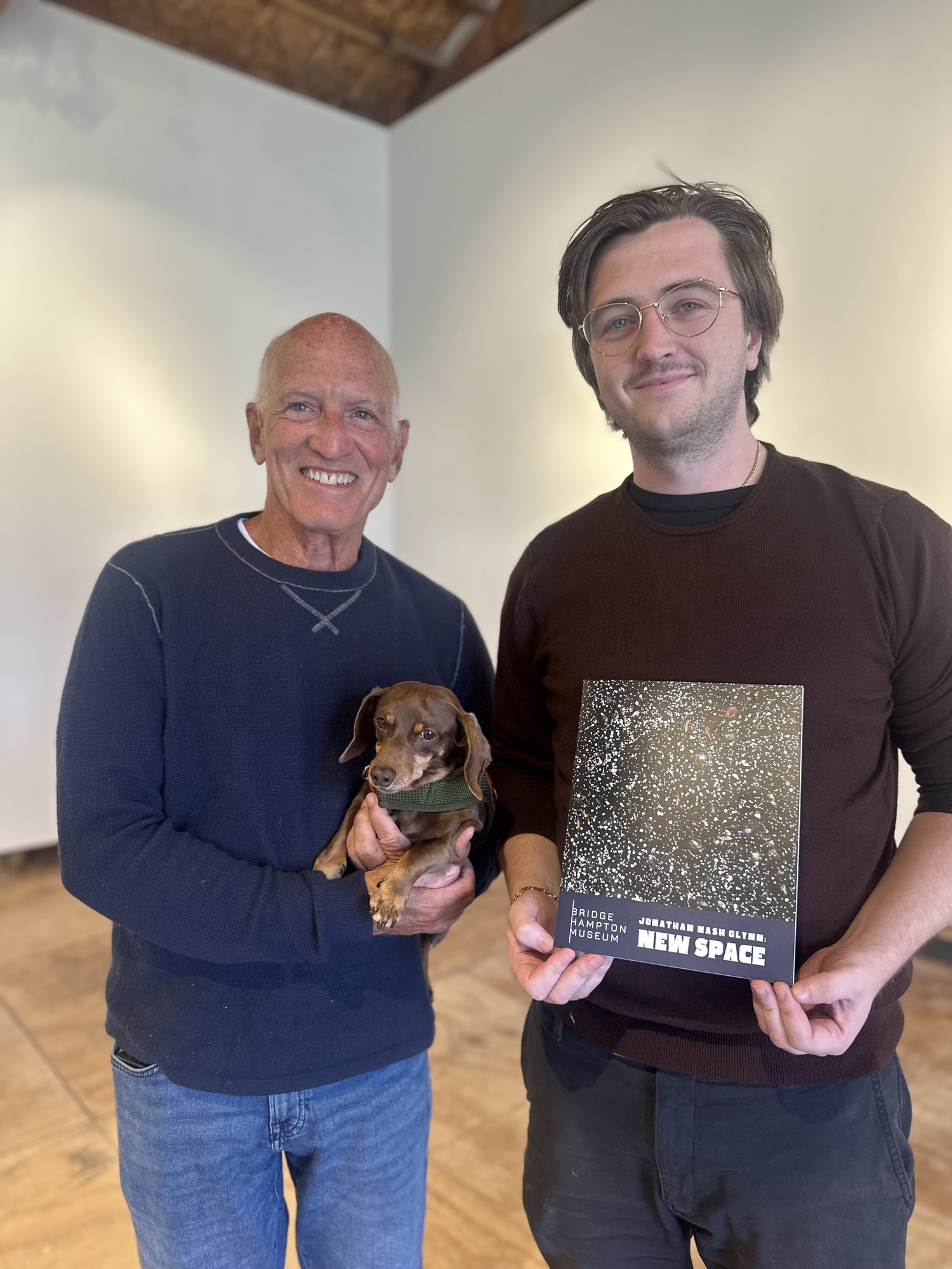 Artist Jonathan Nash Glynn and Connor Flanagan, executive director of the Bridgehampton Museum, with the catalog for Glynn's show 
