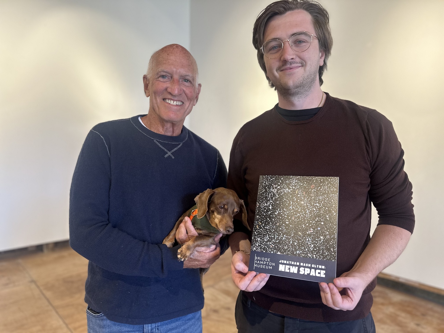 Artist Jonathan Nash Glynn and Connor Flanagan, executive director of the Bridgehampton Museum, with the catalog for Glynn's show 