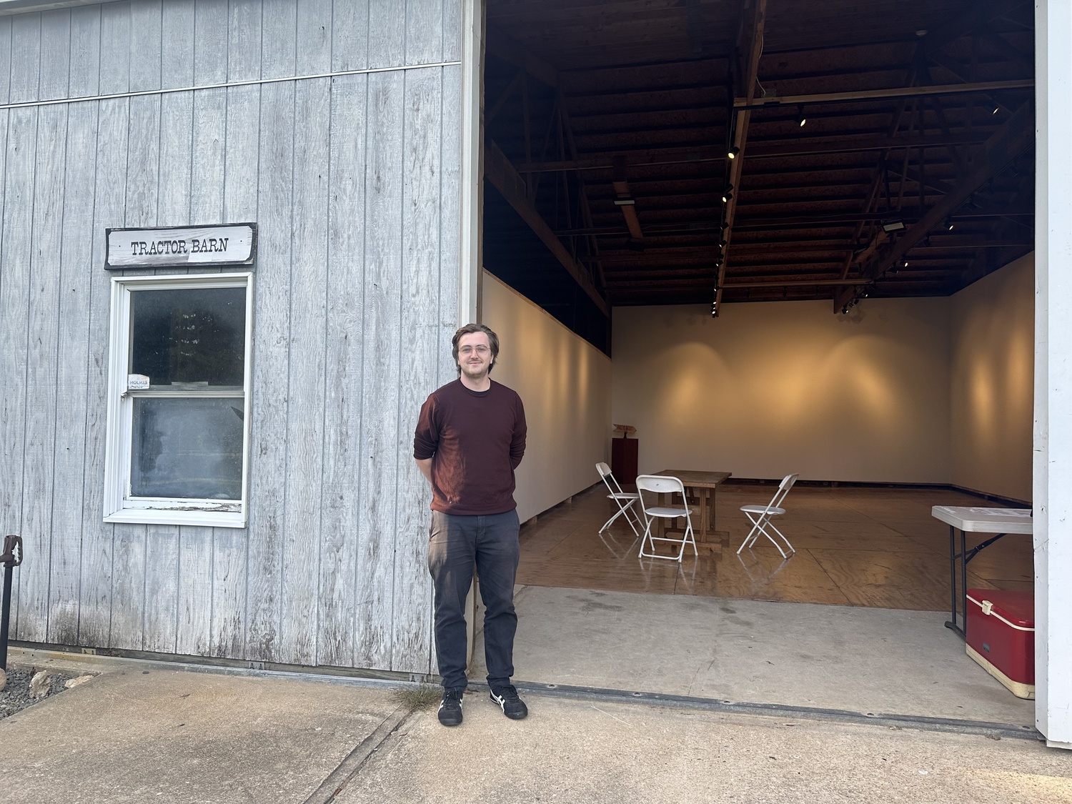 Connor Flanagan, executive director of the Bridgehampton Museum, at the entrance to the newly renovated Tractor Barn on the Corwith House property. ANNETTE HINKLE