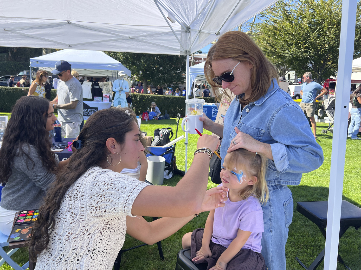 Alexis Spangler and her mom, Iris, at the Ross School's face painting activity on Saturday.