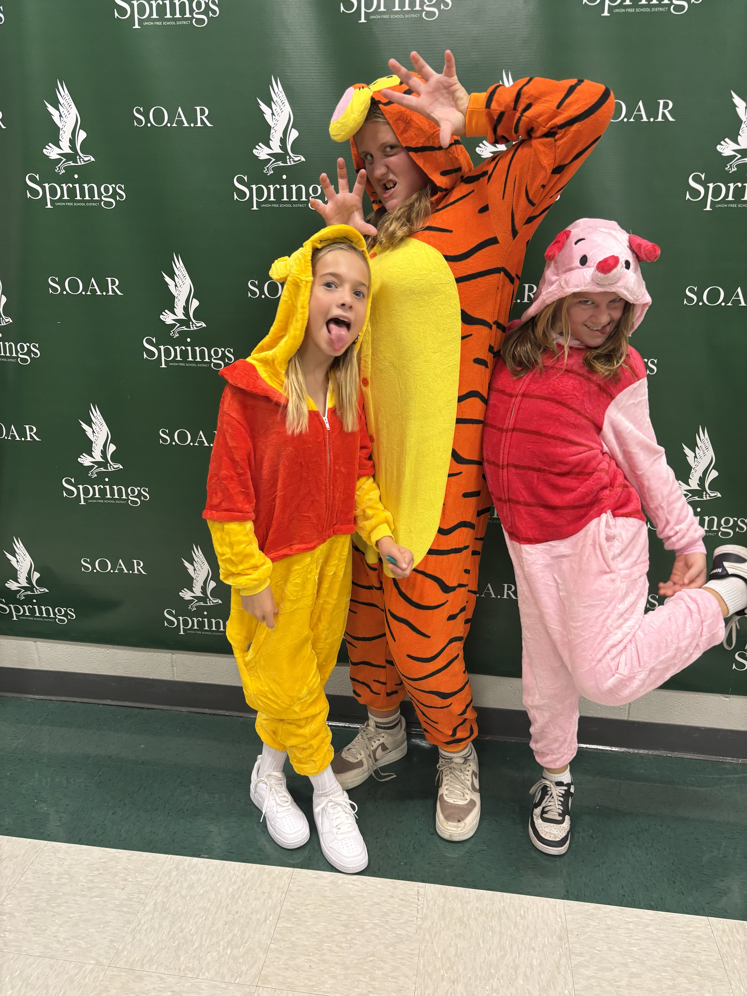 Sixth graders Kacey Kromer, Novi Dunham and Lucy Fagerland were dressed and posing as Winnie the Pooh characters for the middle school Halloween dance.