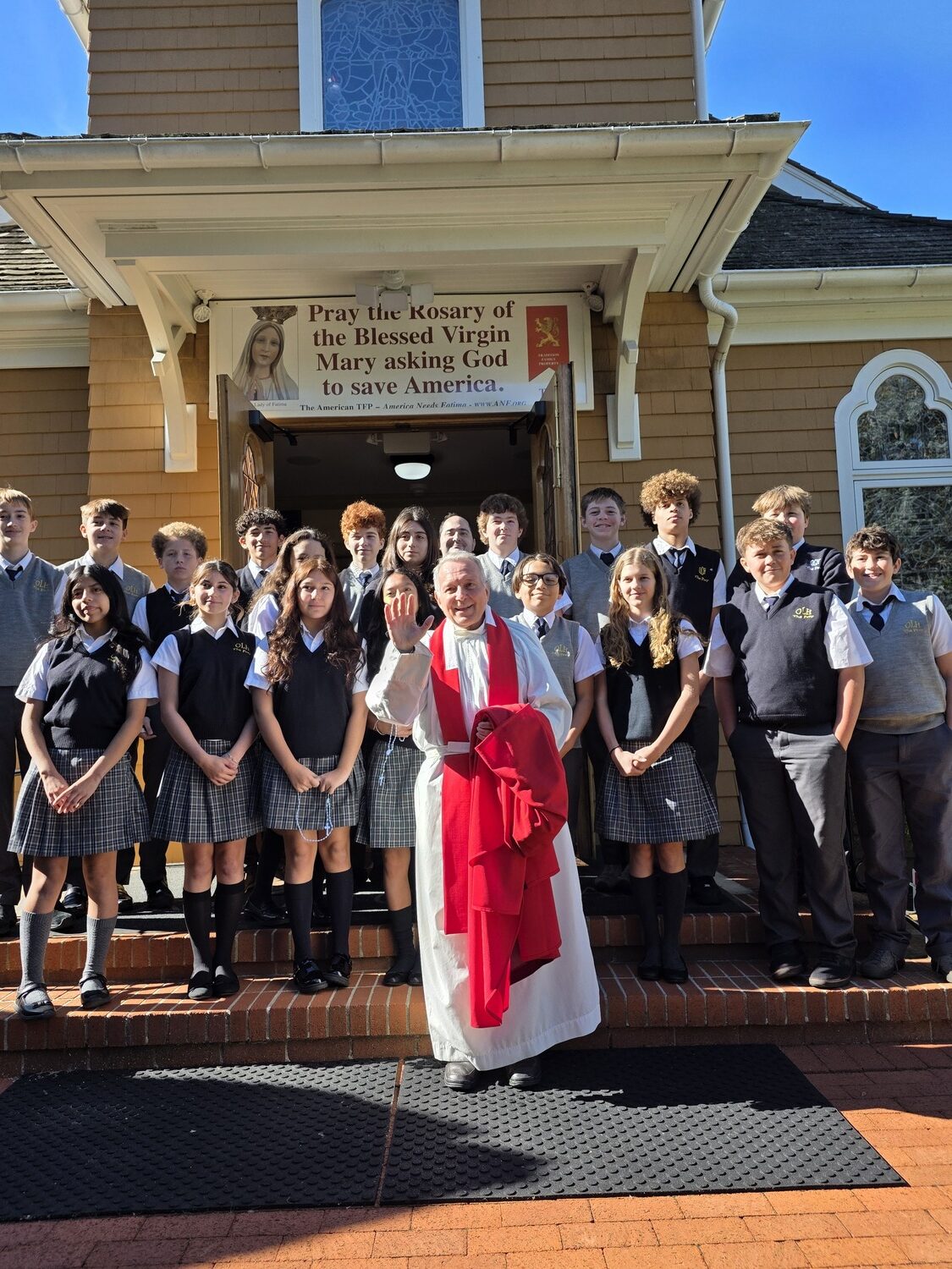 Father Peter DeSantic with the Our Lady of the Hamptons School Prep 8 class after Mass. COURTESY OUR LADY OF THE HAMPTONS SCHOOL