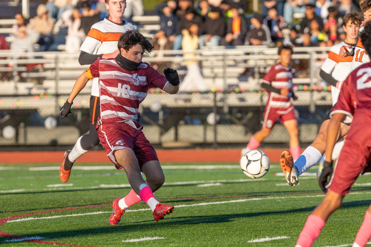 Southampton junior co-captain James Garvin sends a ball before Babylon senior Alex DeSa comes in.  RON ESPOSITO/SOUTHAMPTON SCHOOL DISTRICT