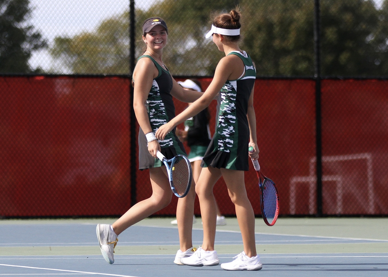 Westhampton Beach seniors Ana Way and Diana Elliott celebrate a point. DESIRÉE KEEGAN
