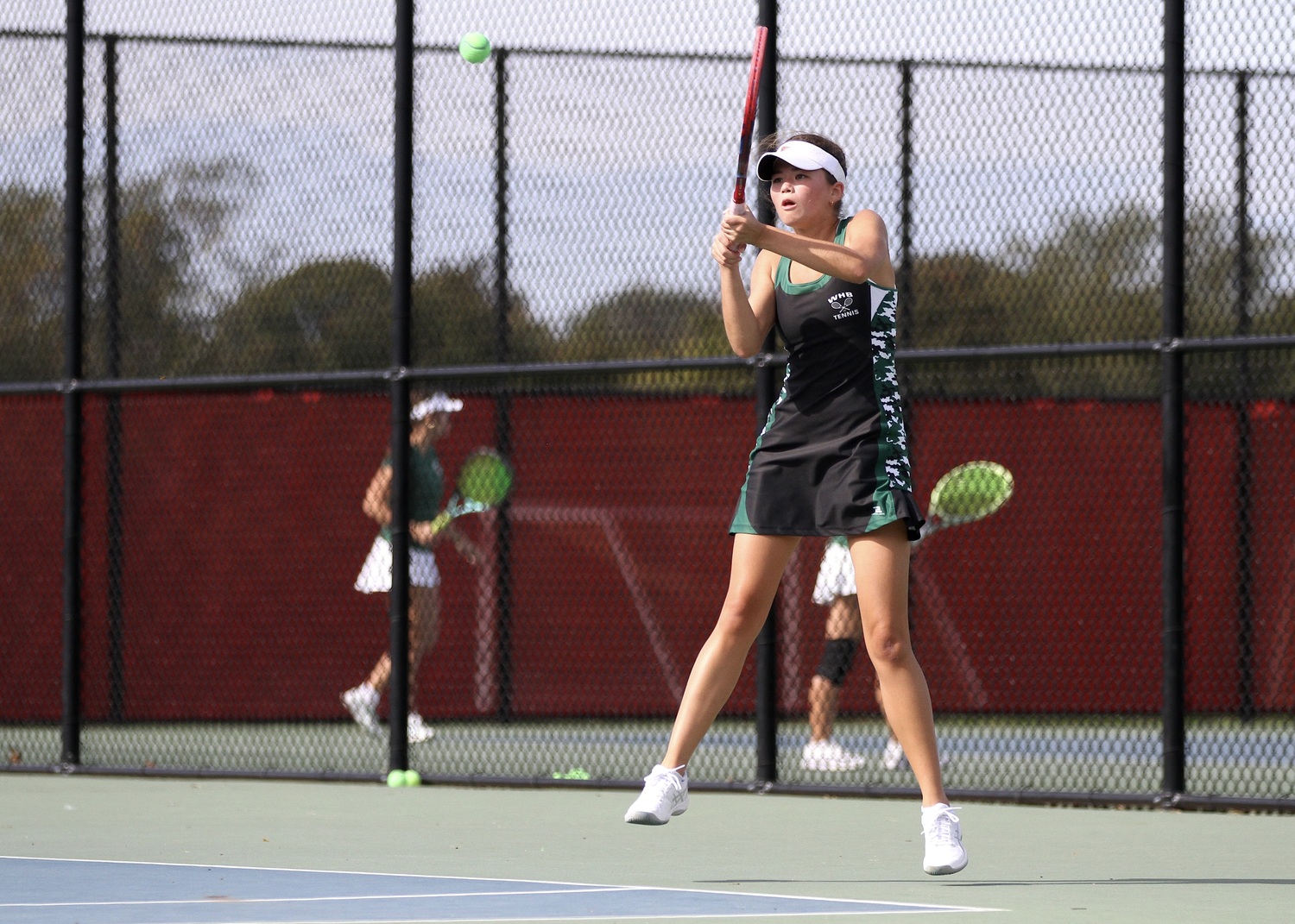 Westhampton Beach senior Diana Elliott powers the ball back over the net. DESIRÉE KEEGAN
