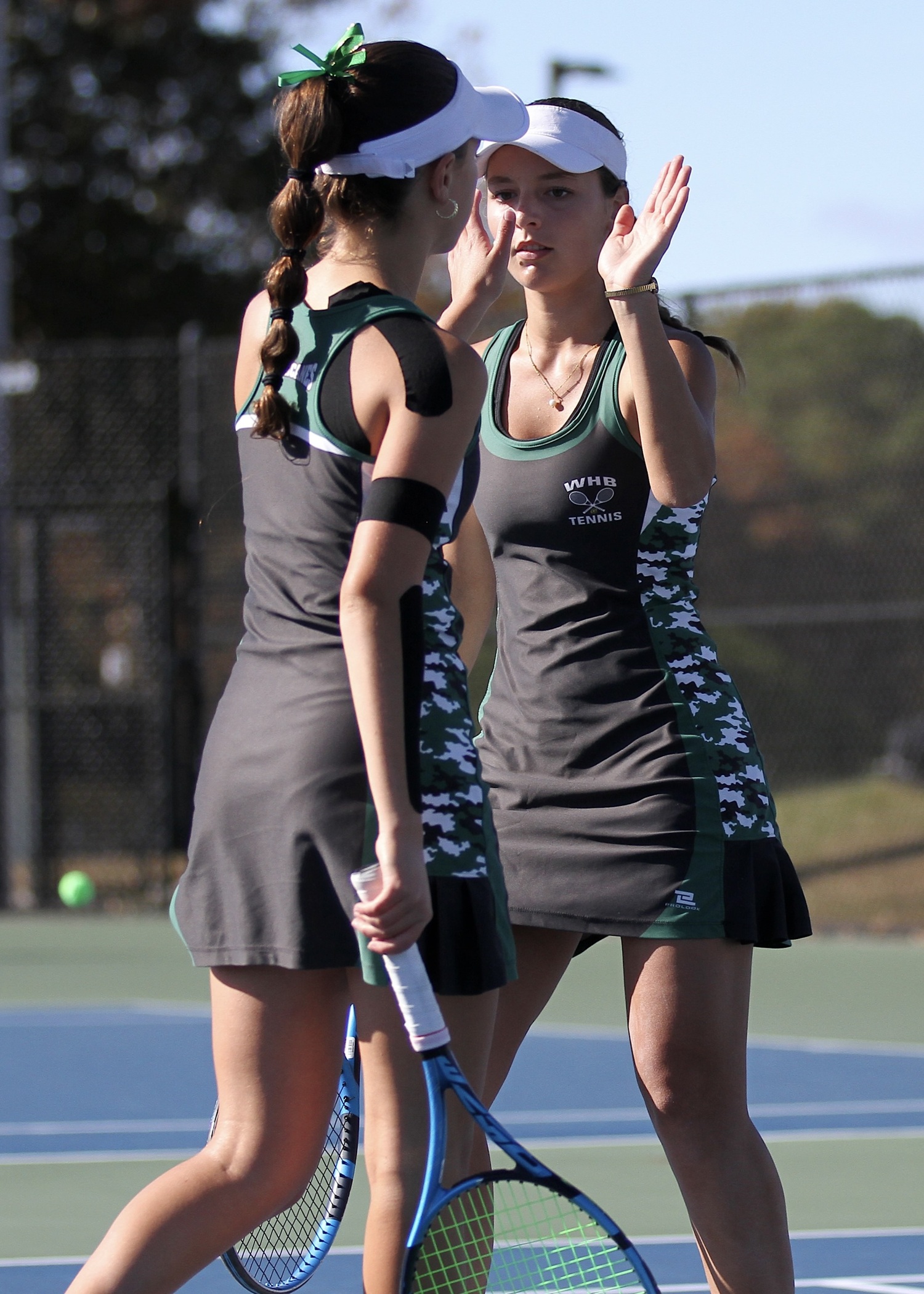 Westhampton Beach freshman Gabriela Arango and junior Zoë Grellet-Aumont celebrate a point. DESIRÉE KEEGAN