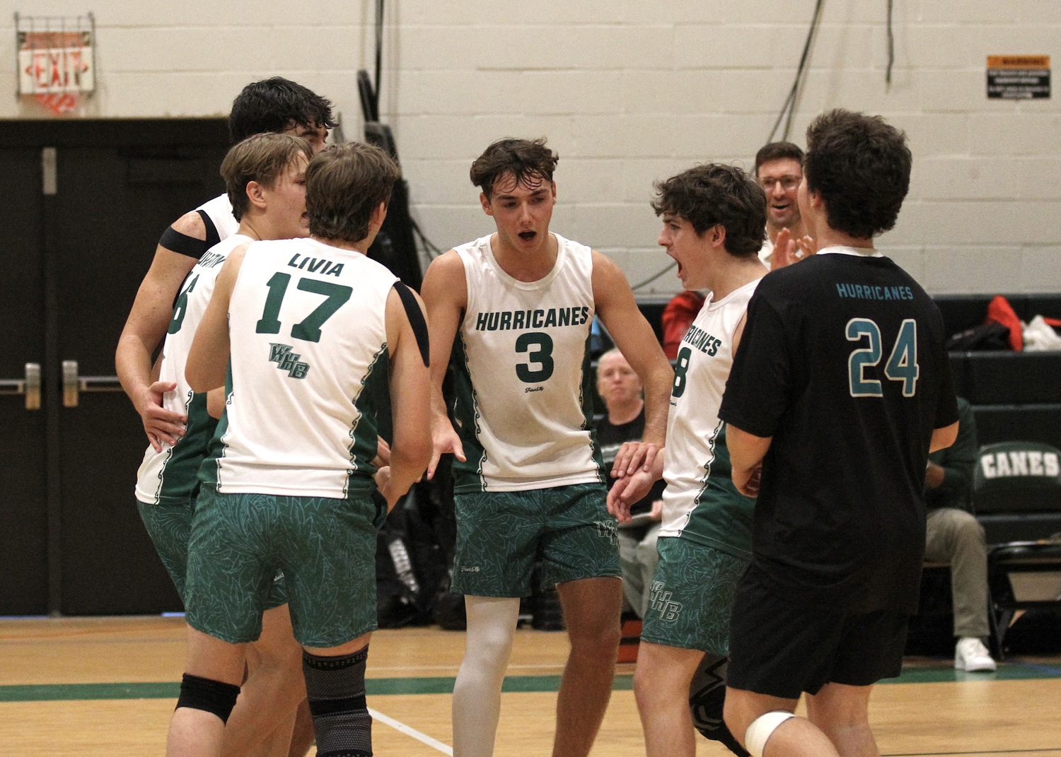 Westhampton Beach senior setter Cameron Giordano celebrates a point with his teammates. DESIRÉE KEEGAN