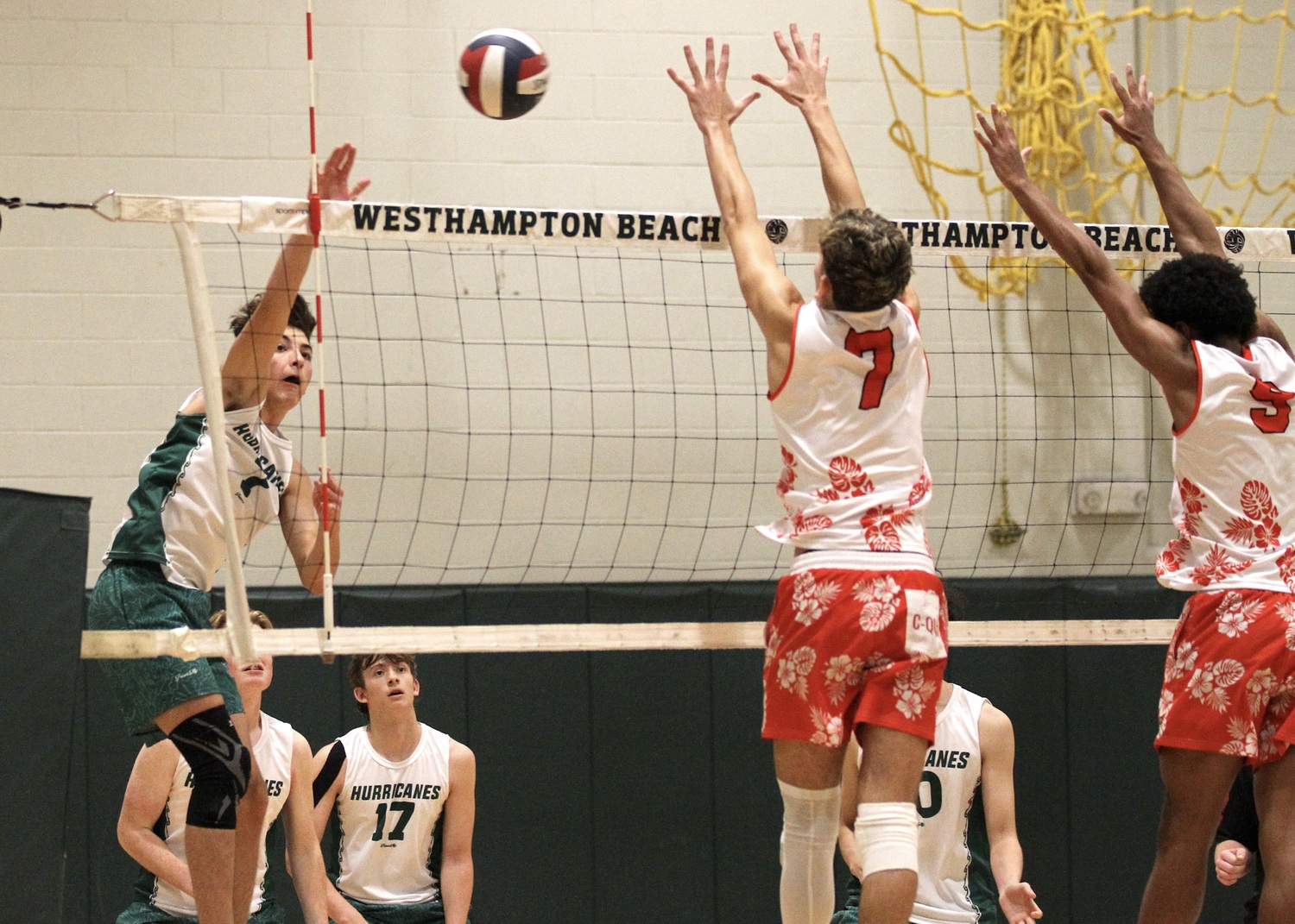 Westhampton Beach junior outside hitter Gabe Monserrate spikes the ball. DESIRÉE KEEGAN