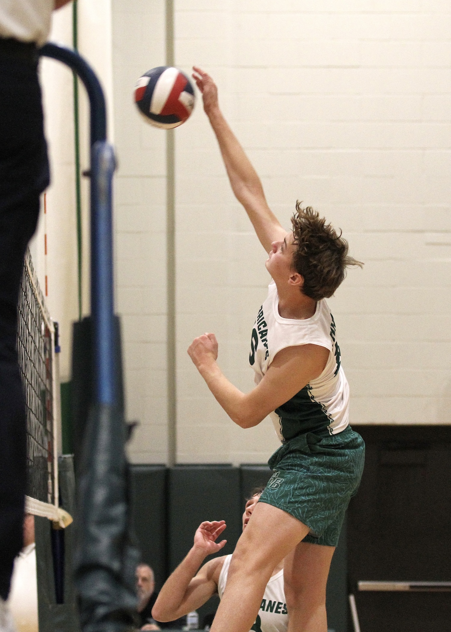 Westhampton Beach sophomore middle hitter Luca Caumartin spikes the ball. DESIRÉE KEEGAN
