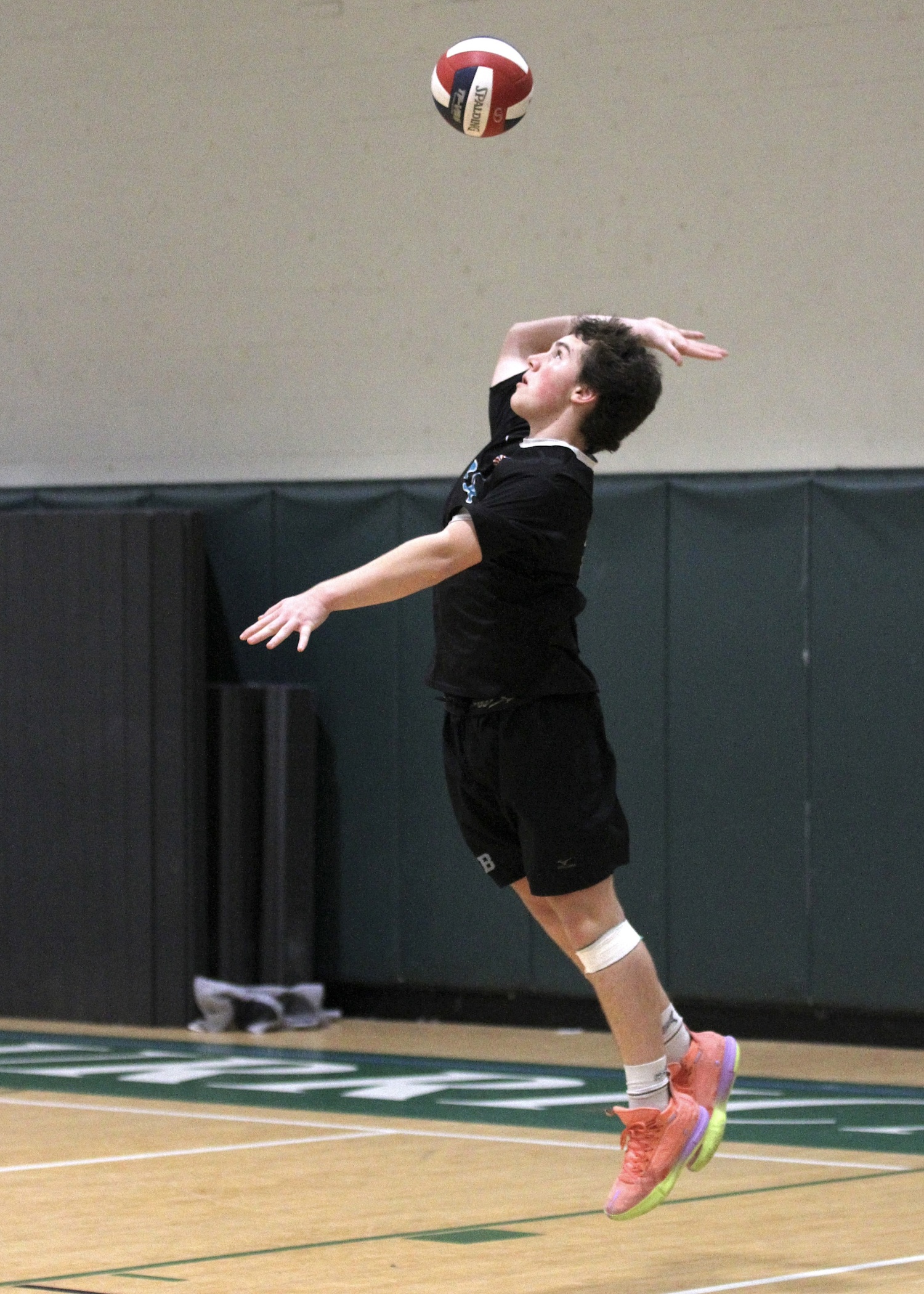Westhampton Beach junior libero Nolan Parsons serves. DESIRÉE KEEGAN