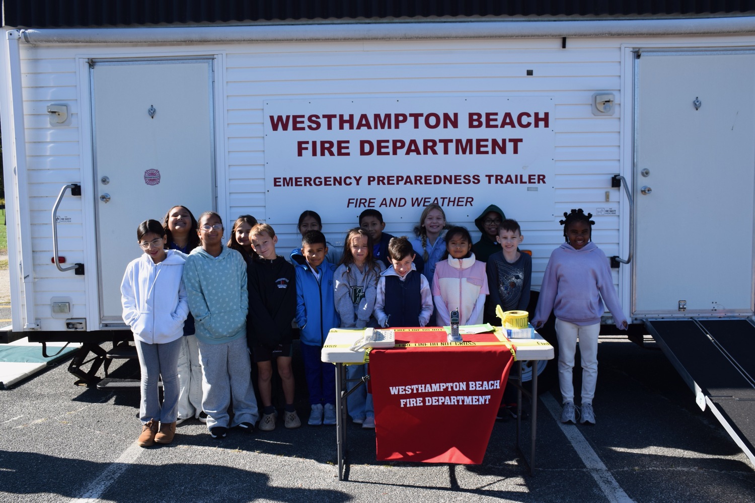 In recognition of Fire Prevention Week, Westhampton Beach Elementary School students took part in hands-on fire safety lessons led by members of the Westhampton Beach Fire Department. Students learned important fire safety practices, including how to use smoke alarms and fire extinguishers, when to call 911 and how to safely exit through a window using the department’s smoke house simulator. COURTESY WESTHAMPTON BEACH SCHOOL DISTRICT