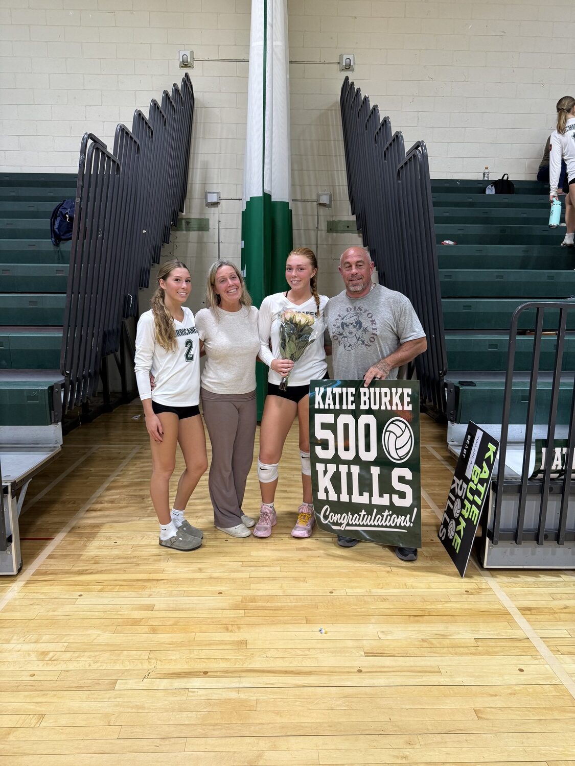 Katie Burke with her younger sister Evie, on left, and parents Nicole and Jeremy Burke. SARAH FABIAN