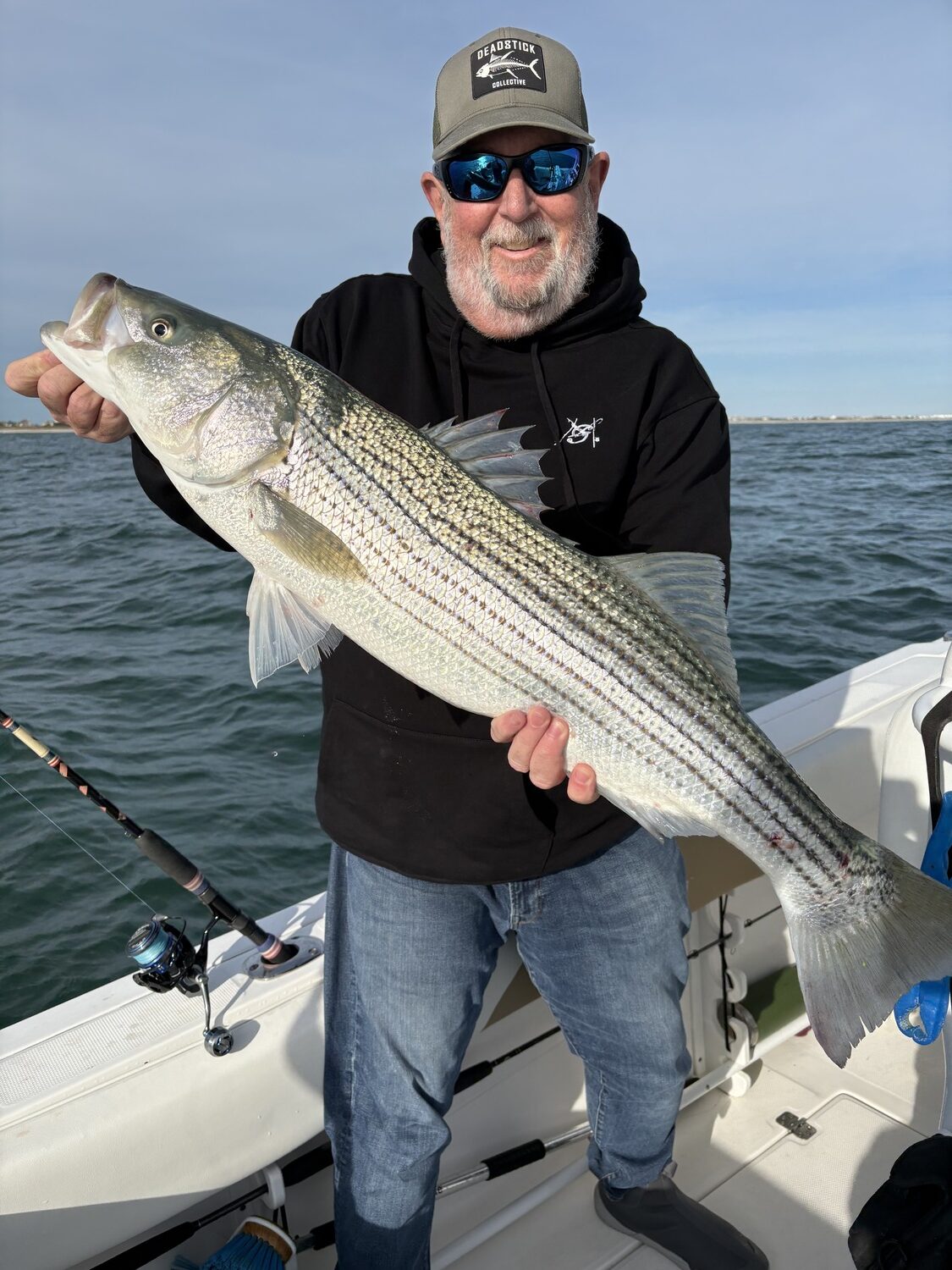 Mike Dean with a nice striped bass during the mid-October push of fish past our shores. The mass of striped bass that lives off our coast is steadily diminishing, with little coming down the pike to rebuild the stock, but fisheries managers declined to take steps to reduce the number of fish killed by fishermen next year. DON MEYER