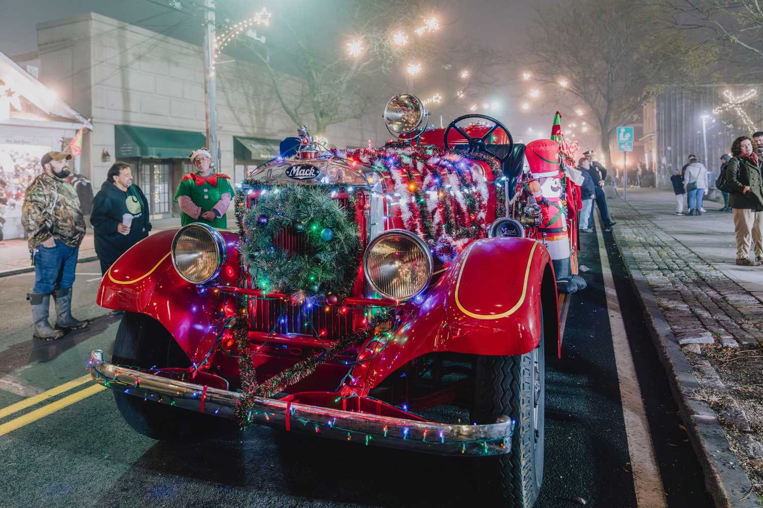 Enjoying holiday lights as guests walk through downtown Greenport is part of the stroll's appeal. Jeremy Garretson photo