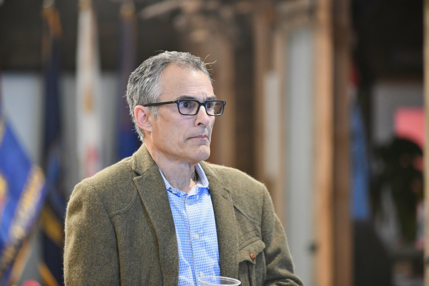 Southampton Trustee candidate Bill Parash watches election results come in at VFW Post 5350 in Westhampton Beach on Tuesday night.  DANA SHAW