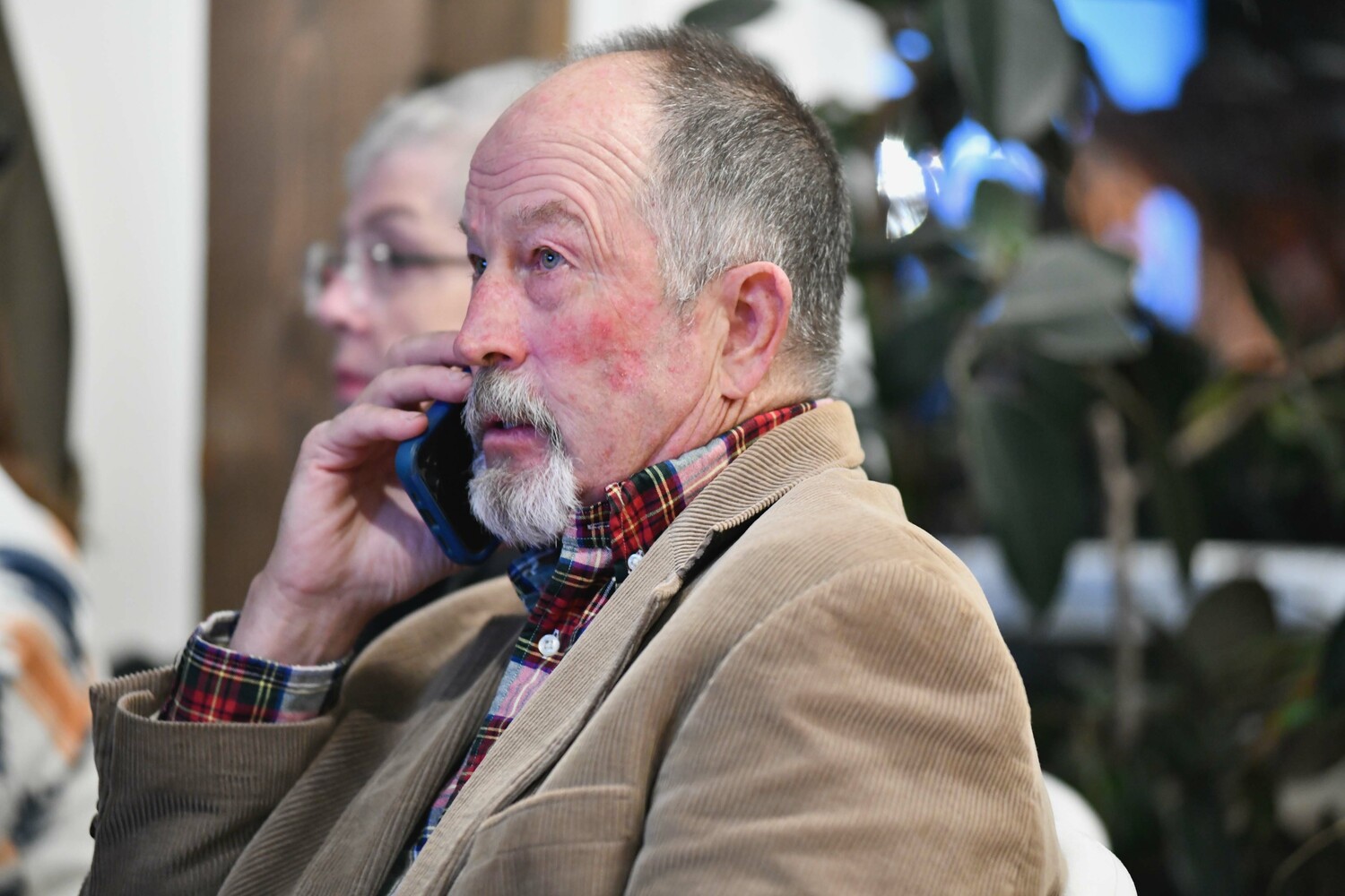 Southampton Town Trustee Ed Warner watches the election results come on Tuesday night in Westhampton Beach.  DANA SHAW
