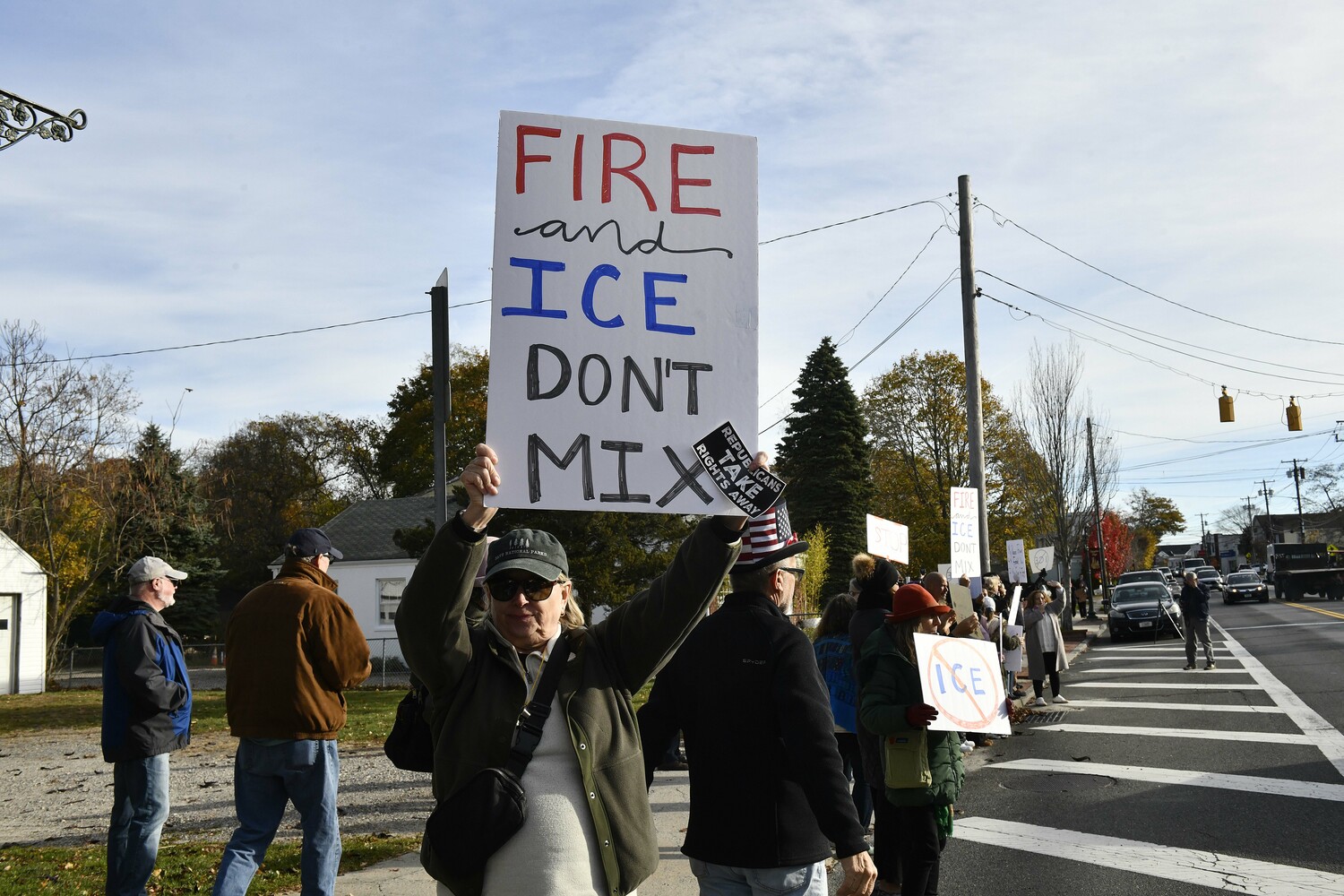 Protesters lined Montauk Highway in Hampton Bays on Friday morning voicing their objections to immigration raids that ensnared several people in the community and in Westhampton and Riverhead earlier in the week. DANA SHAW