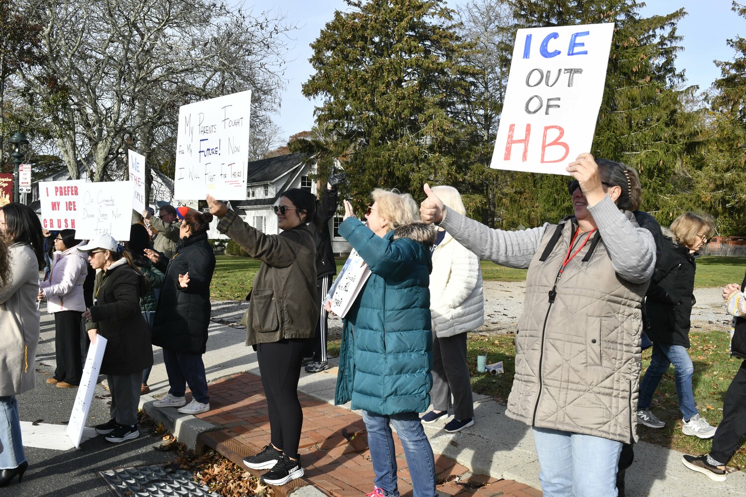 Protesters lined Montauk Highway in Hampton Bays on Friday morning voicing their objections to immigration raids that ensnared several people in the community and in Westhampton and Riverhead earlier in the week. DANA SHAW
