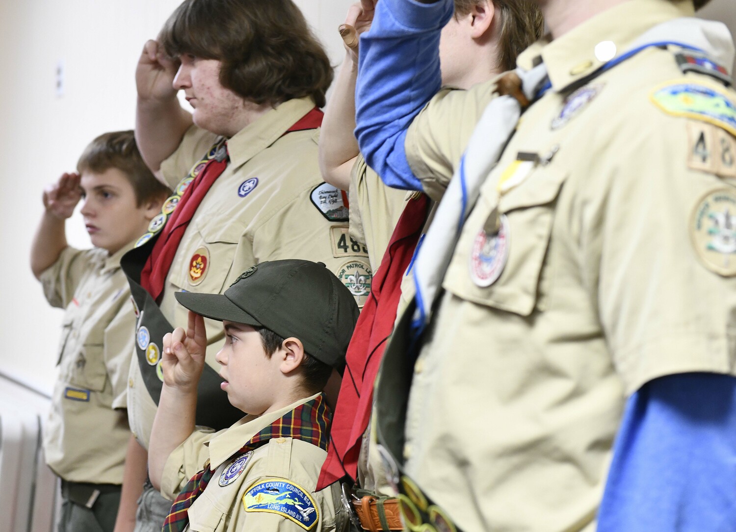 The Hampton Bays Scouts salute the flag.